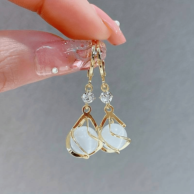 Elegant Monique™ opal gold earrings by Emma & Rose Cape Town, featuring delicate design with shimmering opal stones and gold settings.