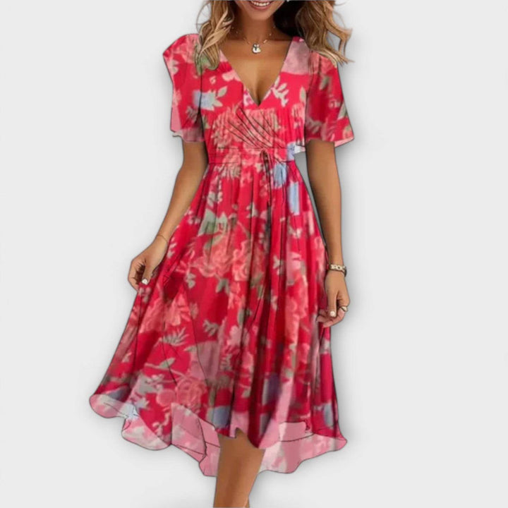 Elegant Clara™ dress by Emma & Rose Cape Town, featuring a flowing fabric and sophisticated design, shown on a model.