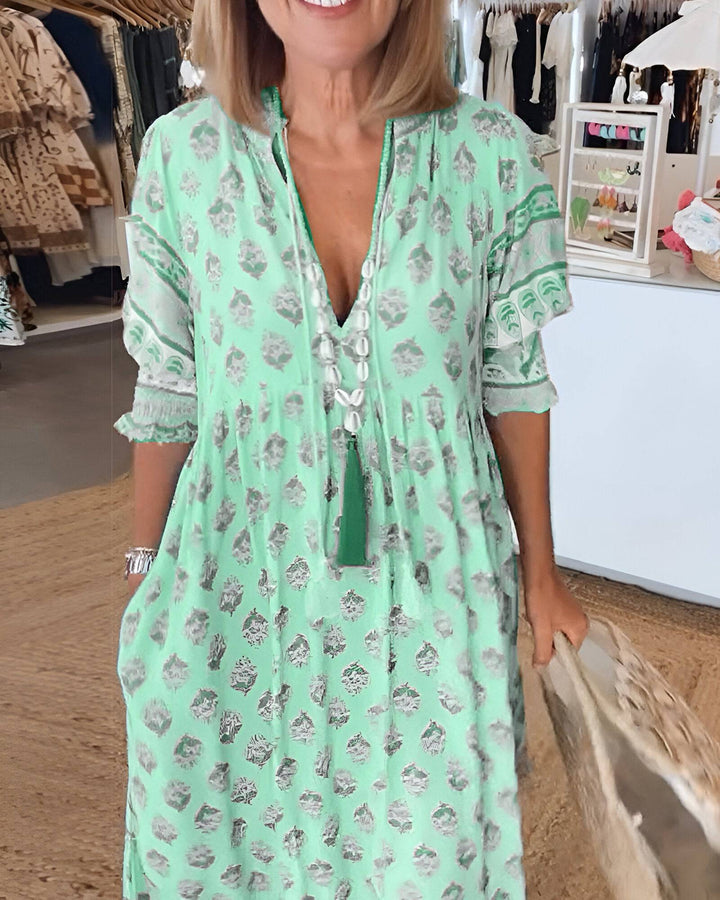 Bérénice™ bright summer dress by Emma & Rose Manhattan, featuring vibrant floral print and lightweight fabric.