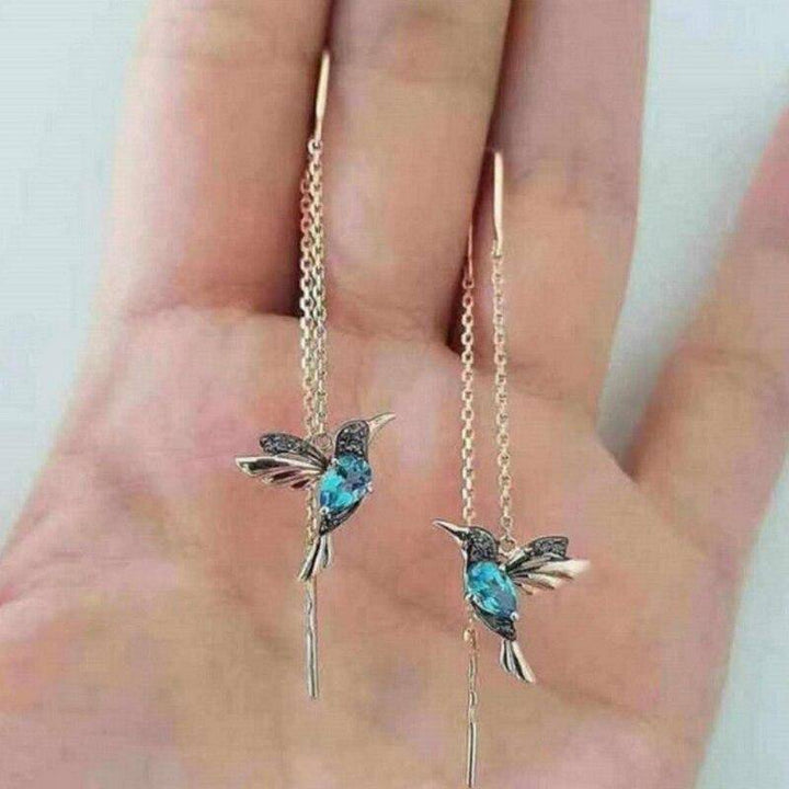 Katniss™ Emma & Rose Cape Town hummingbird earrings with silver chain and long, striking feather accents, stylish and minimalist.