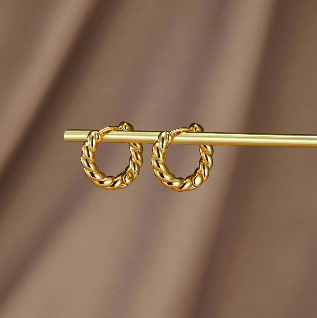 Gold twist earrings from Emma & Rose Cape Town's Krystal™ collection, featuring stylish intertwined design.