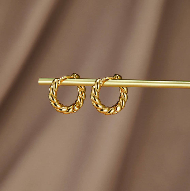 Gold twist earrings from Emma & Rose Cape Town's Krystal™ collection, featuring stylish intertwined design.
