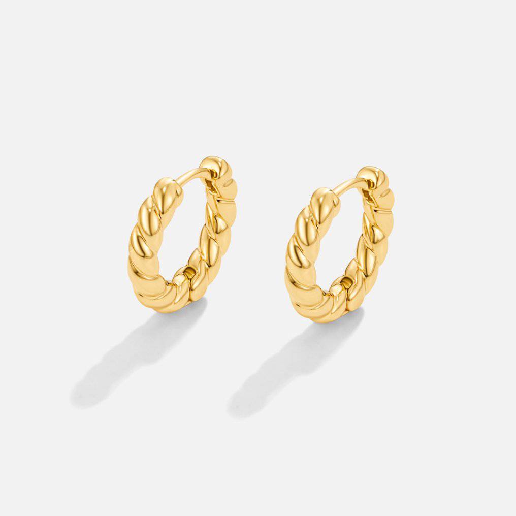 Gold twist earrings from Emma & Rose Cape Town's Krystal™ collection, featuring sleek, stylish design with twisted hoop details.
