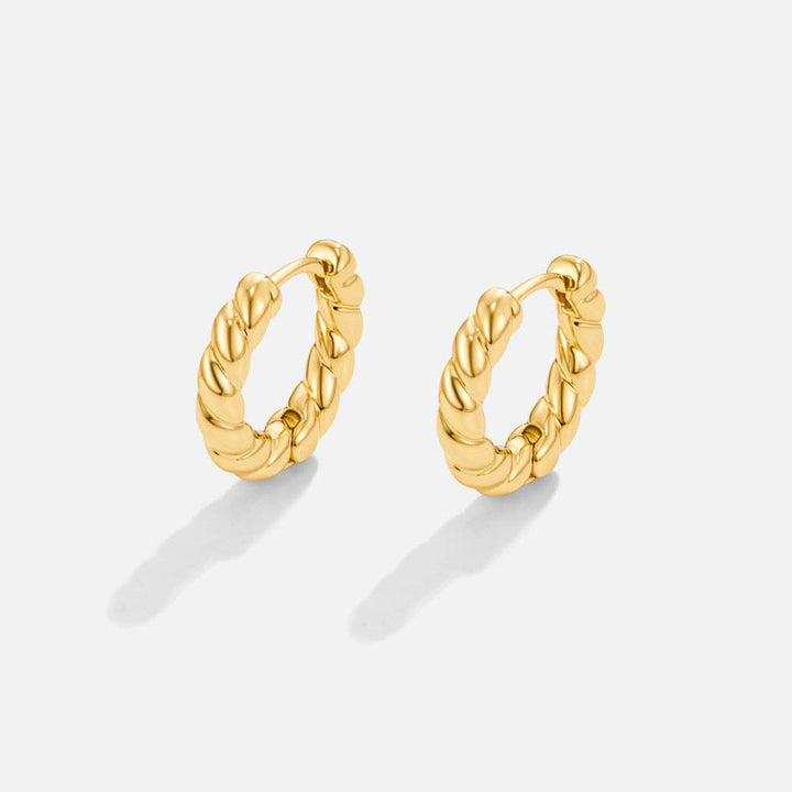 Gold twist earrings from Emma & Rose Cape Town's Krystal™ collection, featuring sleek, stylish design with twisted hoop details.