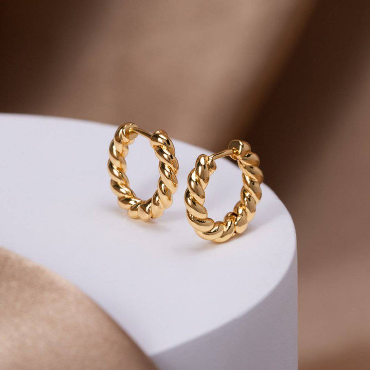Gold twist earrings from Emma & Rose Cape Town’s Krystal™ Stylish Twist Earrings collection, featuring elegant, intertwined design.