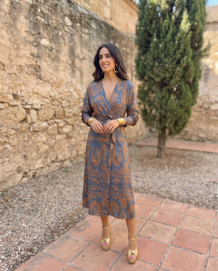 Silvia™ midi dress with colorful print from Emma & Rose Cape Town, shown on a model in a candid fashion photograph.