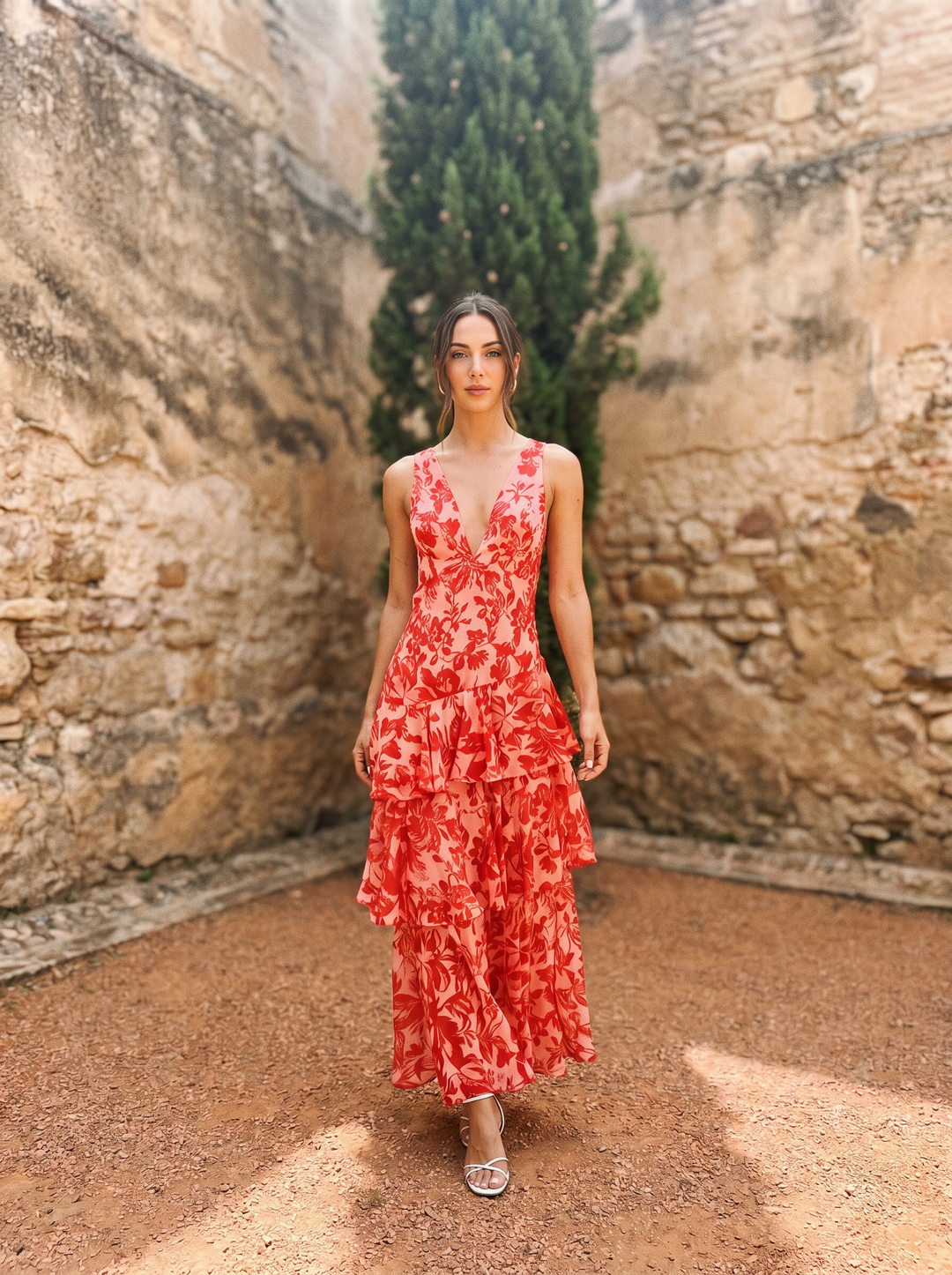 Floral print dress with deep V-neck by Emma & Rose Cape Town, shown on a model with flowing fabric and vibrant pattern.