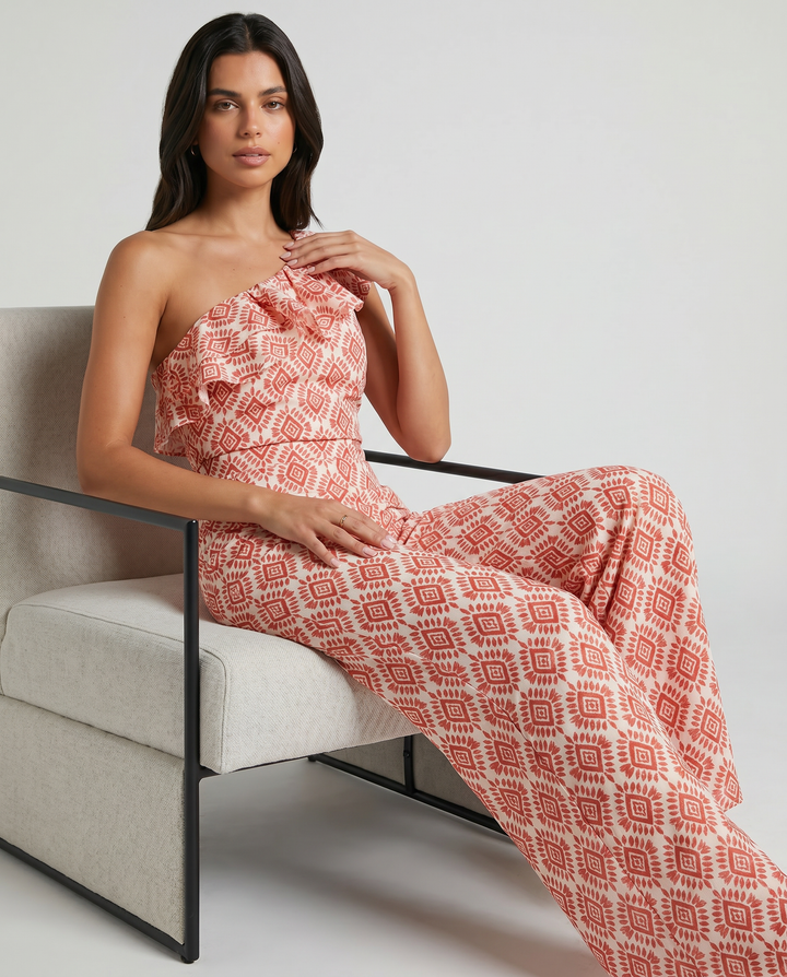 Model wearing the Jimena Spring Geometric Print Jumpsuit by Emma & Rose Cape Town, showcasing the stylish design and vibrant pattern.