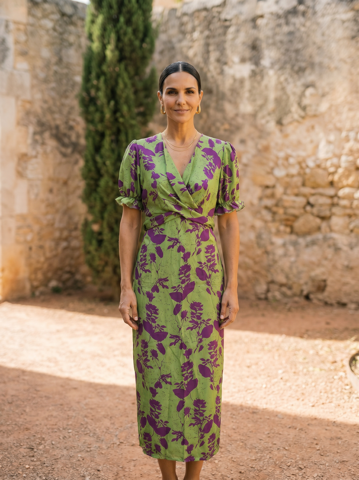 Spring printed dress named Andrea by Emma & Rose Cape Town, featuring a colorful floral design and flowing fabric.