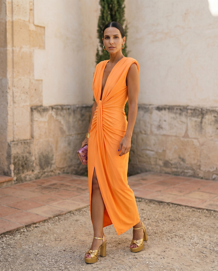 Selena Fiery Draped Dress by Emma & Rose Cape Town, showcasing a vibrant, flowing red dress with elegant draping and intricate details.