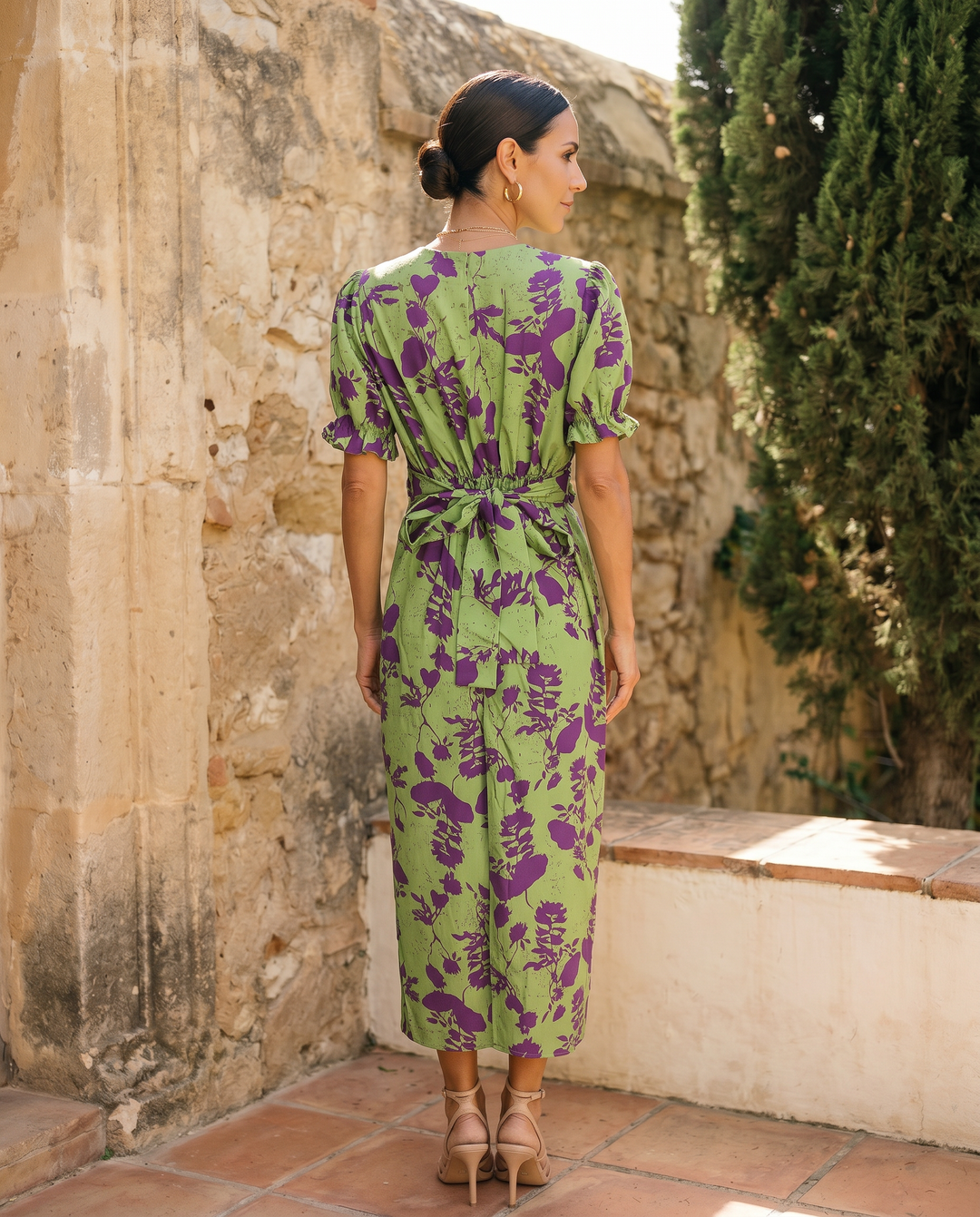 Andrea spring printed dress by Emma & Rose Cape Town shown in a photorealistic image with floral patterns and a flowing design.