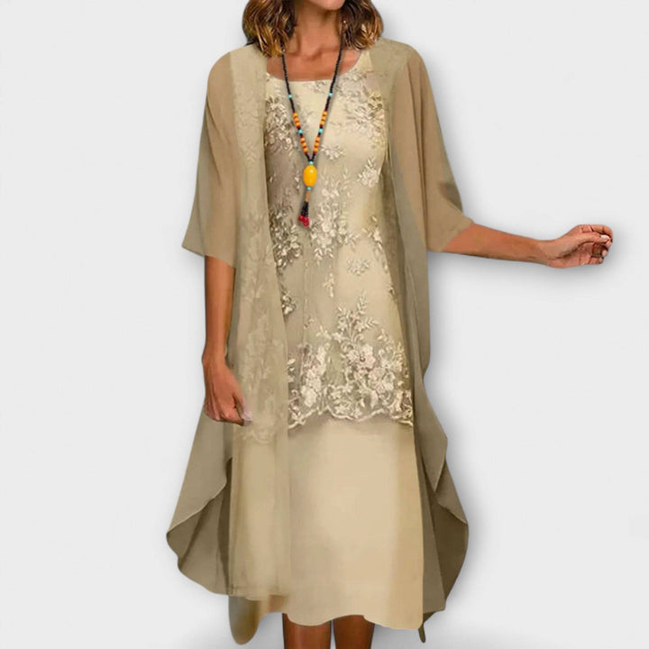 Elegant Penliah™ dress by Emma & Rose Cape Town featuring intricate embroidery and flowing fabric on a mannequin.