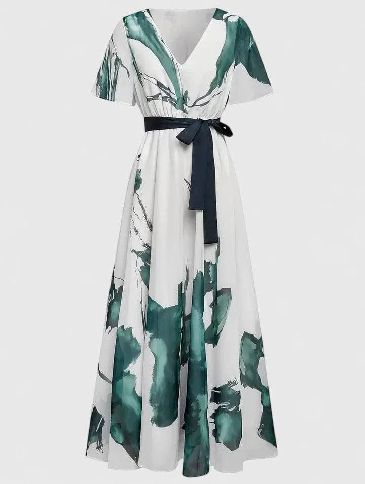 Long watercolor print dress by Xavrynah™ from Emma & Rose Cape Town, featuring a sophisticated, flowing design.