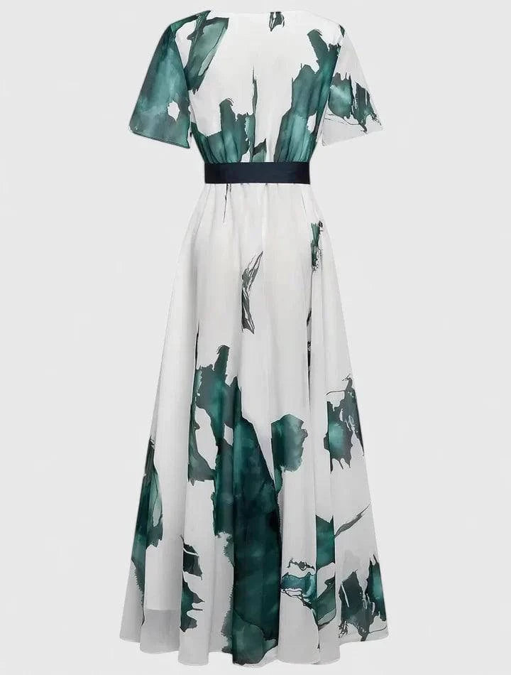 Long watercolor-print dress by Xavrynah™ from Emma & Rose Cape Town, featuring a sophisticated, flowing design.
