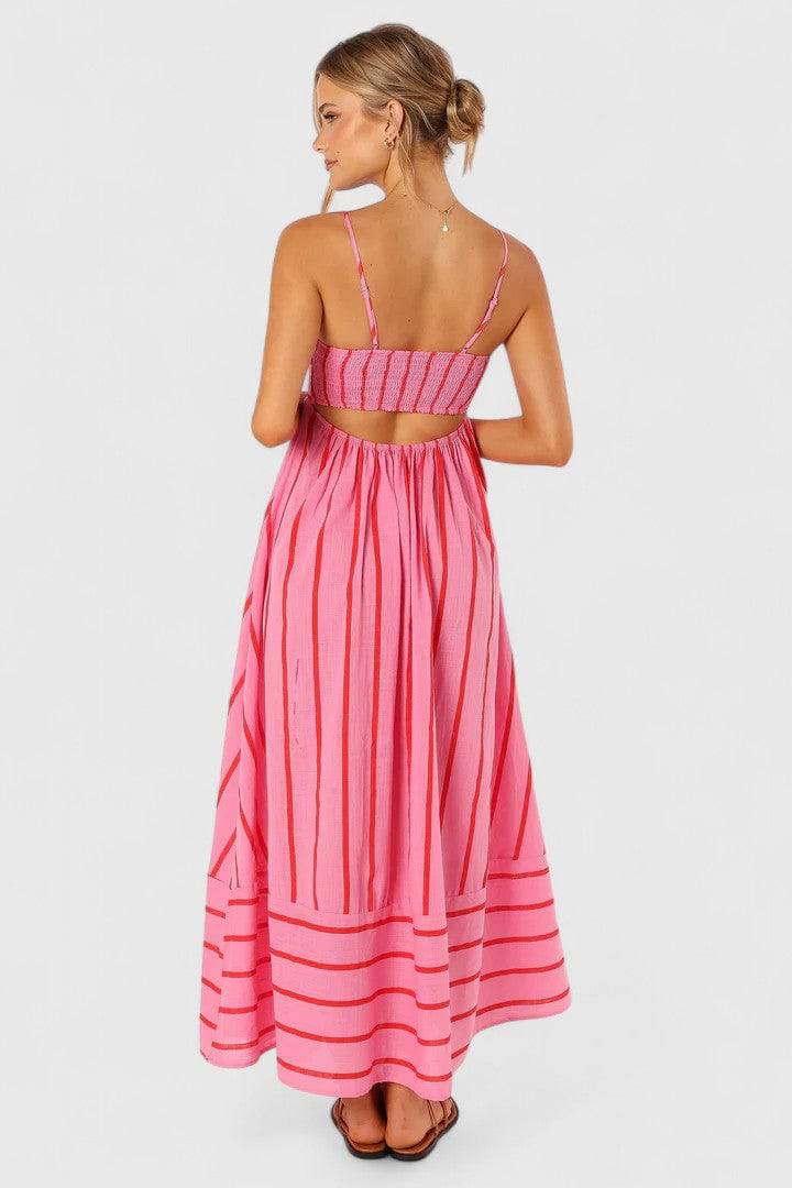 Pink and red petal-patterned Ilyanthe™ maxi dress by Emma & Rose Cape Town featuring flowing fabric and elegant design.