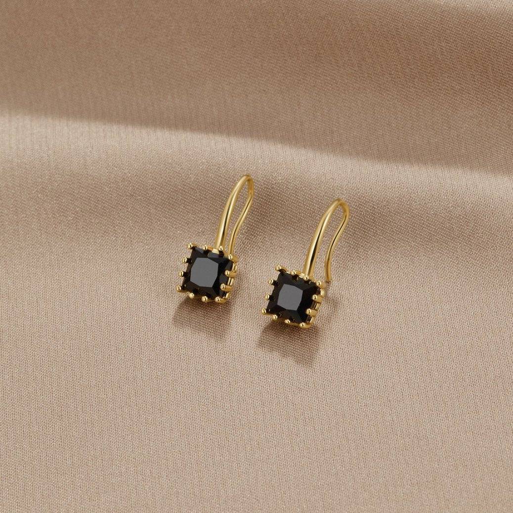 Black crystal drop earrings from the Nicole™ collection by Emma & Rose Cape Town, featuring elegant crystal pendants hanging from hooks.