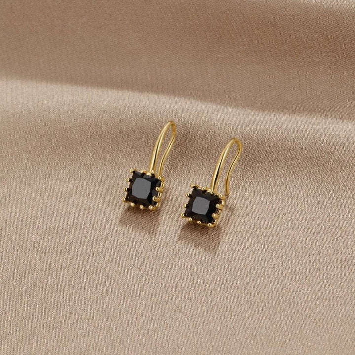 Black crystal drop earrings from the Nicole™ collection by Emma & Rose Cape Town, featuring elegant crystal pendants hanging from hooks.