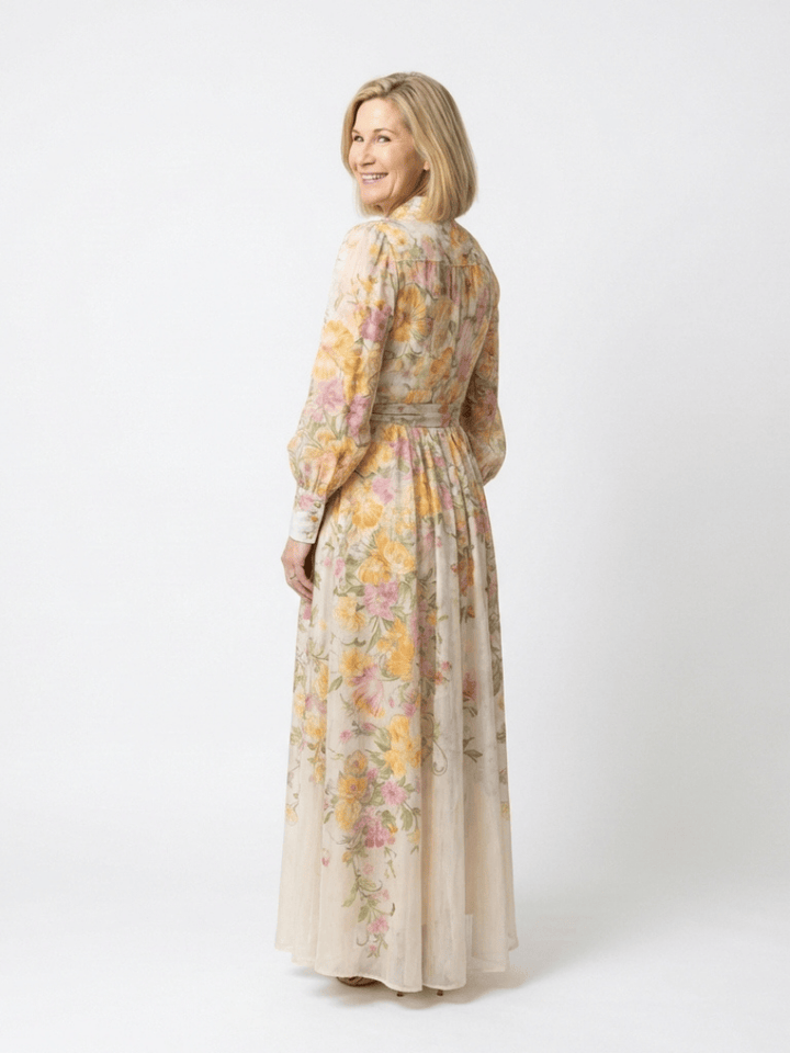 Emma & Rose Cape Town Cressida™ floral sheer long dress displayed on a model with flowing fabric and intricate floral patterns.